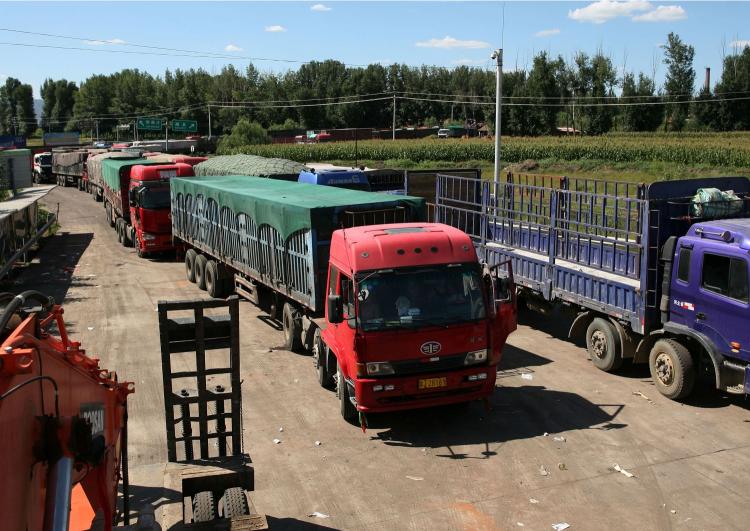 Chinese trucks on the highway leading towards Beijing in Guo Lei Zhuang, north China's Hebei province, on August 23, the ninth day of a 62-mile-long traffic jam leading to Beijng.  (STR/AFP/Getty Images)