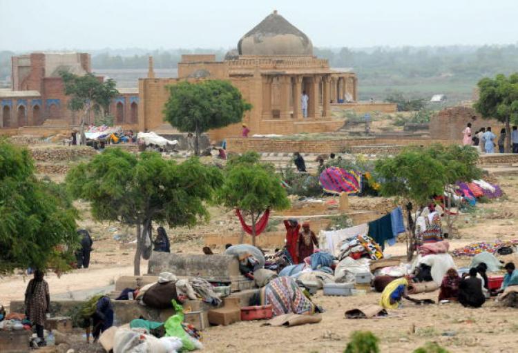 Pakistani flood survivors take shelter in southern Sindh province's Makli on August 31. Flood waters that have devastated Pakistan, covering a fifth of the country and leaving at least 1,600 people dead, are now draining into the Arabian Sea.   (Rizwan Tabass/Getty Images )