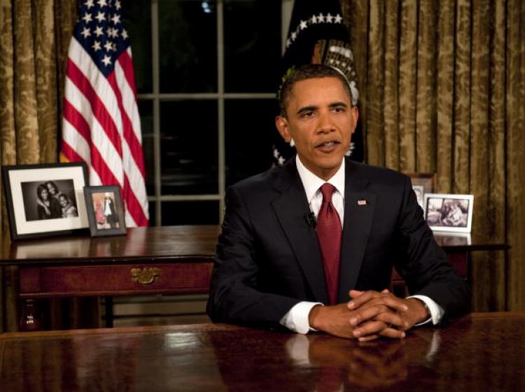 IRAQ COMBAT MISSION ENDS: U.S. President Barack Obama reads his speech to photographers after delivering an address to the nation on the end of combat operations in Iraq from the Oval Office of the White House in Washington on Aug. 31.  (Nicholas Kamm/Getty Images)