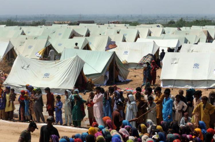 Pakistanis displaced by floods queue for relief goods at a Pakistan's navy distribution point in a makeshift camp in Thatta district on September 2, 2010. (Rizwan Tabassum/AFP/Getty Images)