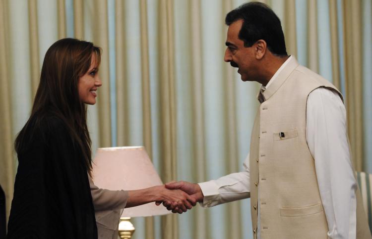 US actress and UNHCR Goodwill Ambassador Angelina Jolie shakes hands with Pakistani Prime Minister Yousaf Raza Gillani in Islamabad on September 8. Jolie visited Pakistan's northwest September 7 to draw the world's attention towards the plight of 21 million people affected by the country's worst-ever floods. (Farooq Naeem/Getty Images)