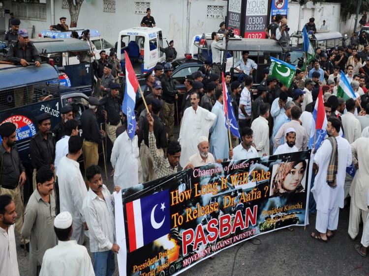 Pakistani police block a street toward the US consulate during a protest rally by political parties and human rights activists in Karachi on September 22, 2010, against the detention of a Pakistani woman Aafia Siddiqui in the United States. (Asif Hassan/AFP/Getty Images)
