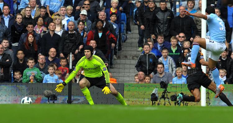 Man City's Argentinian striker Carlos Tevez (R) shoots past Chelsea's Czech goalkeeper Petr Cech to score the only goal of the English Premier League football match at the City Of Manchester Stadium in Manchester, Sept. 25. (Andrew Yates/AFP/Getty Images)