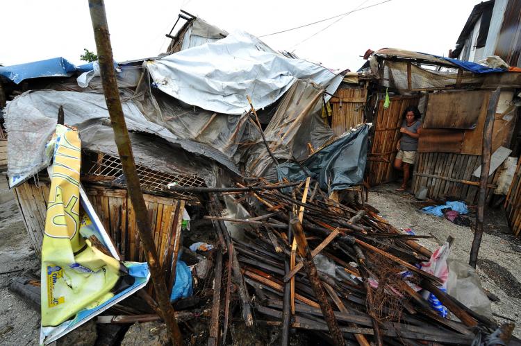 A woman surveys her house, destroyed by the strong winds of typhoon Megi in a slum area in Manila Bay on October 19, 2010. The strongest typhoon to hit the Philippines in years killed at least 10 people as it generated waves as big as houses and destroyed swathes of vital rice crops, authorities said. (Noel Celis/AFP/Getty Images)