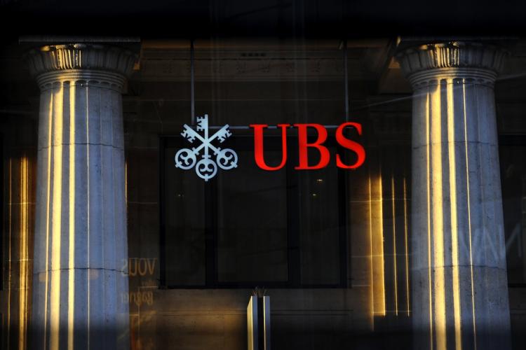 Switzerland's largest bank UBS, is seen through a window in Lausanne. UBS is implementing a strict new dress code for employees.