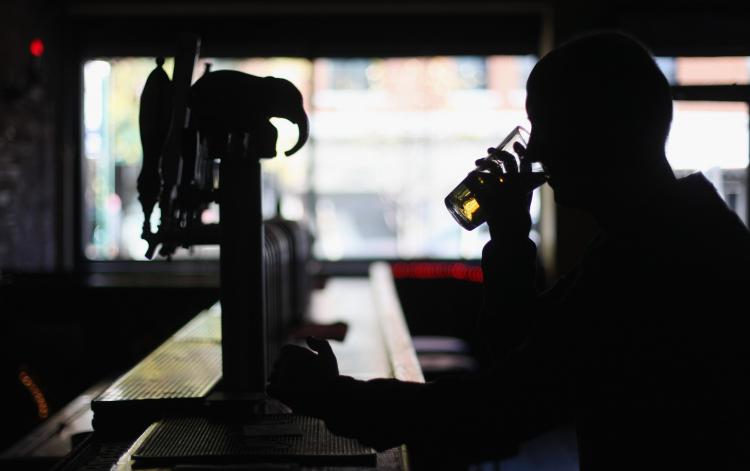 A man drinks a beer in a Manhattan bar November 1, 2010 in New York City. A new study ranks alcohol as more dangerous than  drugs like crack cocaine and heroin based on how destructive the substances are to society and the individual as a whole.  ( Mario Tama/Getty Images )