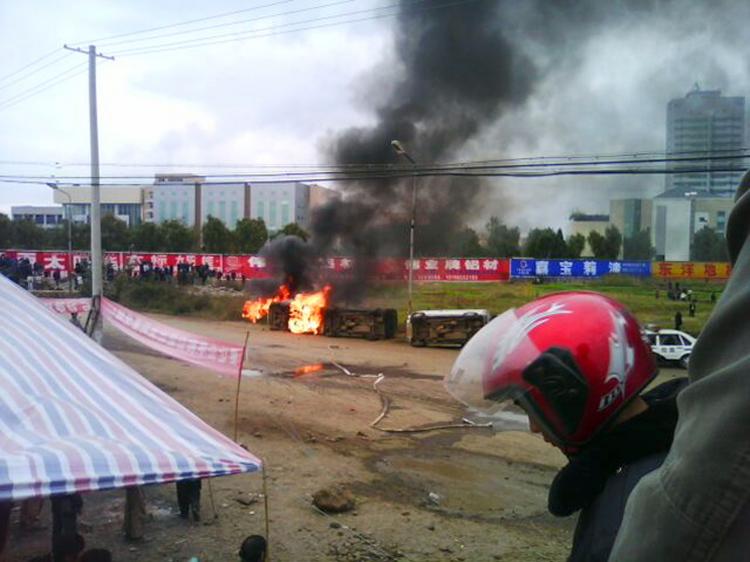 Vehicles burn after hundreds of Chinese villagers battled with local police over corrupt  land seizures in Zhaotong, in southwest China's Yunan province on November 2, 2010. (AFP/Getty Images)