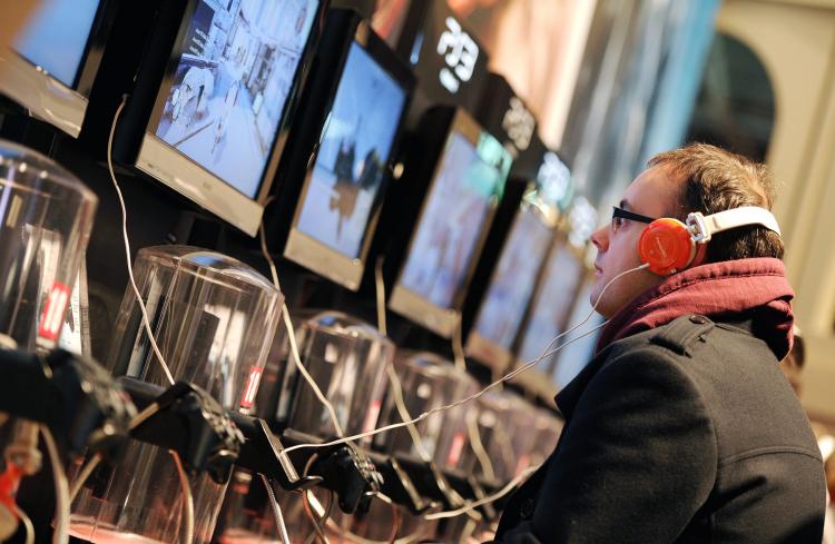 A man plays on a PS3 games console last October in Paris. Sony said on Tuesday that hackers may have been able to access personal information of more than 77 million PlayStation Network customers, including passwords, purchase history, and billing address. (Franck Fife/Getty Images)