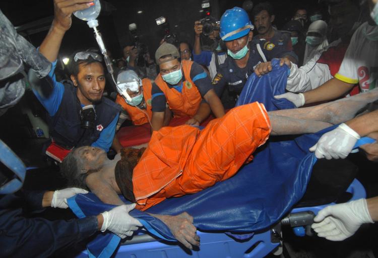 VOLCANO ERUPTION: An ash covered victim of Mount Merapi eruption arrives at a hospital in Yogyakarta on Nov. 5. (Sonny Tumbelaka/AFP/Getty Images)