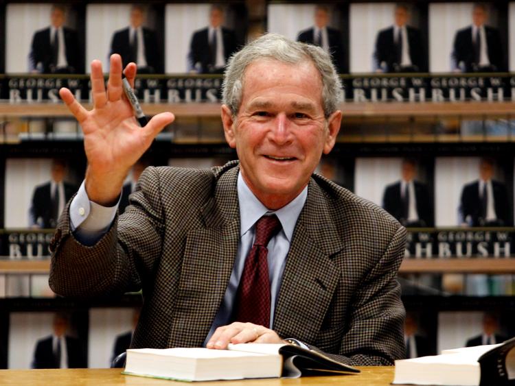 Former U.S. President George W. Bush waves while signing copies of his new memoir 'Decision Points' at Borders Books on November 9, 2010 in Dallas, Texas (Photo by Tom Pennington/Getty Images)