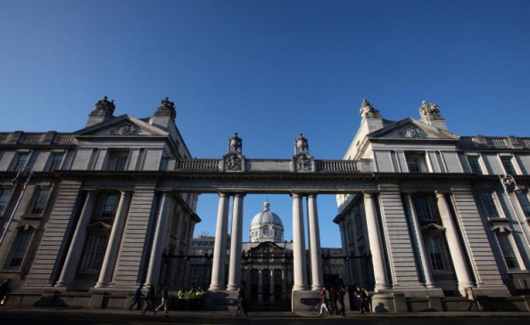 People walk past the front of the Government buildings in Dublin, on November 23, 2010. The city council has taken a narrow focus on the benefits that twinning with China might bring without looking at how the communist regime treats citizens. (Peter Muhly/AFP/Getty Images)