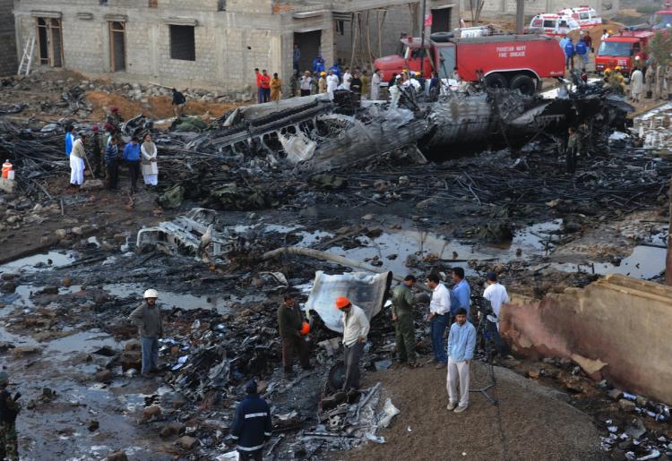 Pakistani rescuers gather on the site where a cargo plane crashed after taking off from Karachi on November 28. (Asif Hassan/Getty Images) Pakistani rescuers gather on the site where a cargo plane crashed after taking off from Karachi on November 28. (Asif Hassan/Getty Images)
