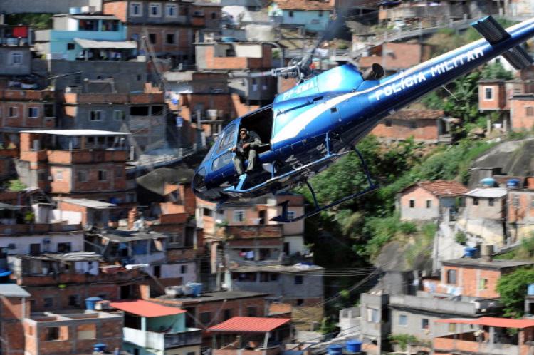 A military helicopter overflies the Morro do Alemao shantytown, during the raid on Nov. 28, 2010 in Rio de Janeiro, Brazil.  (Evaristo Sa/AFP/Getty Images)