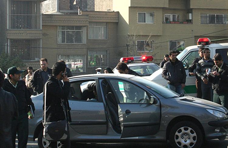 Police are seen standing close to a vehicle allegedly belonging to prominent nuclear scientist Majid Shahriari who was killed. (AFP/Getty Images)