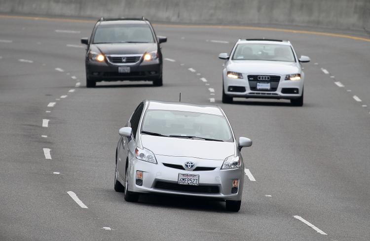 A Toyota Prius (C) drives along highway 101 on November 30, 2010 in Sausalito, California. The NHTSA found that acceleration issues in Toyota cars that prompted a slew of recalls for the Japanese automaker were not due to electronic flaws. (Justin Sullivan/Getty Images)