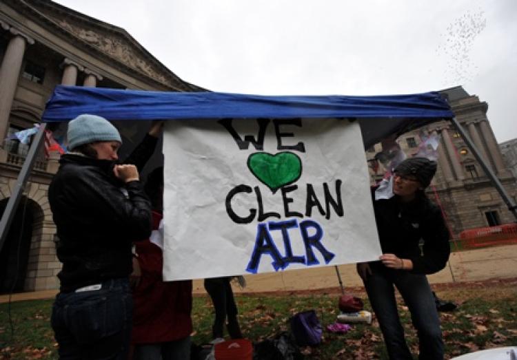 Environmental activists display placards. (Jewel Samad/Getty Images)