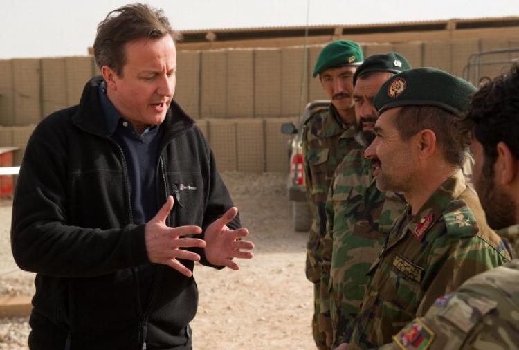 David Cameron (L) speaks to Afghan National Army soldiers at Patrol Base 2 between Lashkar Gah and Gereshk on December 6, 2010 in Helmand Province, Afghanistan. (Leon Neal - WPA Pool/Getty Images)