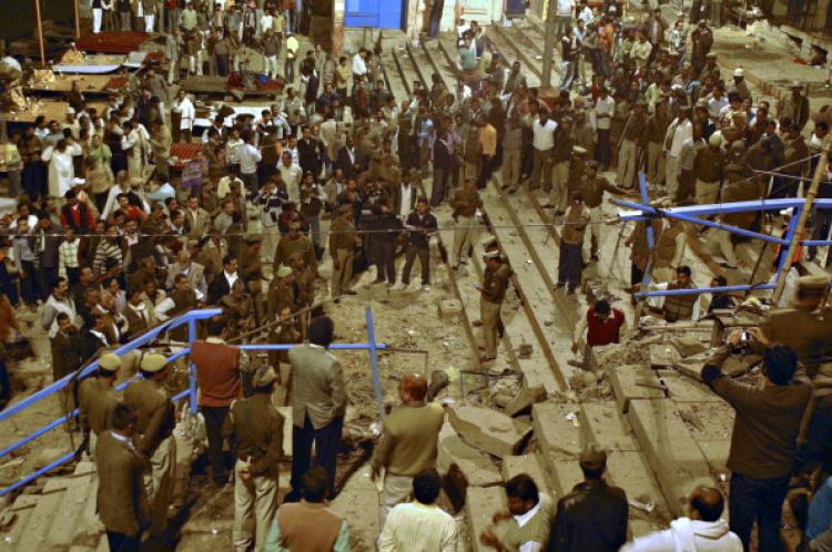 Security officials and onlookers gather at the site of a blast at a 'ghat' (bathing point) in Varanasi on Dec. 7, 2010.  (STRDEL/AFP/Getty Images)