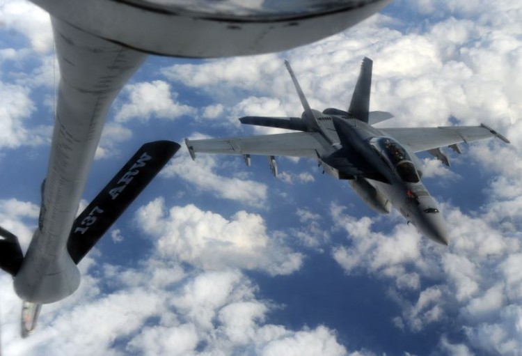 GOING GREEN: A US Navy FA-18 Super Hornet approaches an air refuelling tanker.The U.S. Air Force has nearly completed certifying its fleet to use carbon-intensive coal-to-liquid fuels. (Toshifumi Kitamura/AFP/Getty Images)