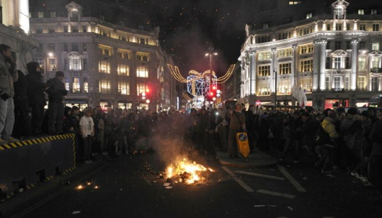 Protesters stand around a fire in Oxford Circus during demonstrations against an increase in fees, in central London, on Dec. 9, 2010.  (Carl Court/AFP/Getty Images)