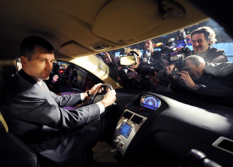 One of the richest men of Russia, Mikhail Prokhorov, sits on December 13, 2010 in a Sport Coupe variant of the E-mobile hybrid cars during the vehicle's presentation in Moscow. (Natalia Kolesnikova/AFP/Getty Images)