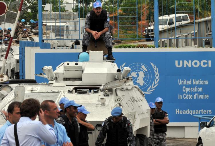 UN peacekeepers in Ivory Coast man their position near a line of barbed wire at the entrance of the UNOCI headquarters in Abidjan on Dec. 20. (Sanogo/AFP/Getty Images)