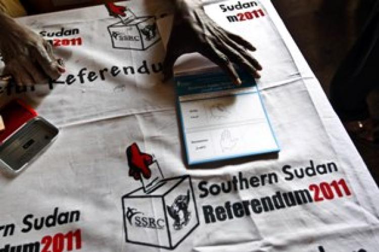 An electoral official holds a block of ballot papers during voting preparations in Khartoum on Jan. 9, 2011. (Khaled Deskouki/Getty Images)