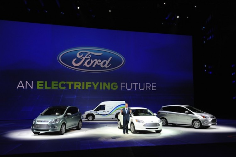 HYBRIDS SCUTINIZED: Bill Ford, executive chairman of Ford Motors stands with (L-R) different hybrid cars during the 2011 North American International Auto Show Jan. 10 in Detroit, Mich.  (Stand Honda/Getty Images)