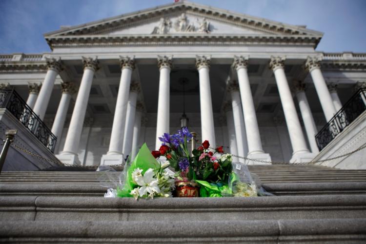 Flowers left by well-wishers are stack on the center steps of the U.S. Capitol to honor the victims of Saturday's mass shooting in Arizona January 10, 2011 in Washington, DC.  (Chip Somodevilla/Getty Images)