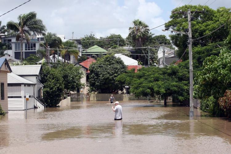 Residents brave the flood waters on January 12, 2011 in Brisbane. The heavy downpour brought by the La Nina weather cycle broke rainfall records throughout Australia. Meteorologists say with changing conditions, La Nina is finally coming to an end this.  (Bradley Kanaris/Getty Images)