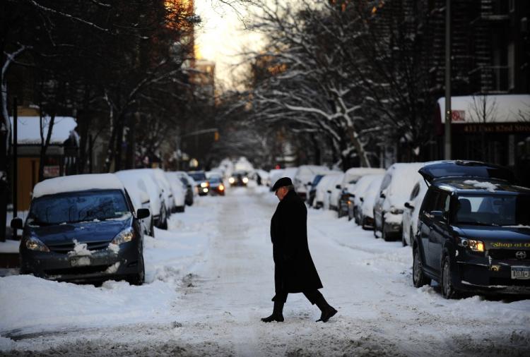 A man crosses a street as fresh snow fell overnight in New York, January 12, 2011.  (Emmanuel Dunad/AFP/Getty Images)