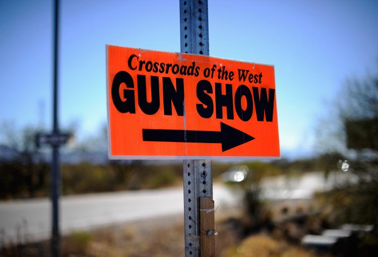 A sign advertises the Crossroads of the West Gun Show at the Pima County Fairgrounds on January 15, 2011 in Tucson, Arizona.   (Kevork Djansezian/Getty Images)