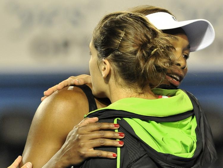 Venus Williams of the US (R) hugs Andrea Petkovic of Germany after retiring from her third round women's singles match on the fifth day of the Australian Open tennis tournament in Melbourne on January 21, 2011. (Paul Crock/AFP/Getty Images)