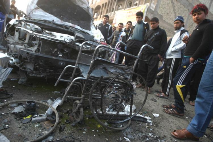 Iraqis gather at the scene of a car bomb that detonated outside a mourning tent during a funeral ceremony in a Shiite Muslim Shuala neighborhood of the capital Baghdad killing some 48 people on January 27, 2011. (Ahmad Al-Rubaye/AFP/Getty Images)