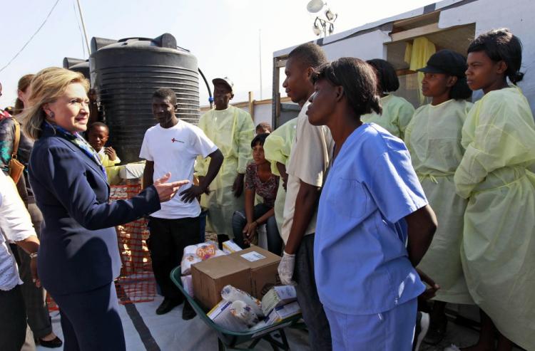 Hillary Clinton talks with workers as she visits Partners in Health Cholera Treatment Center in Port-au-Prince on January 30, 2011.  (Alex Brandon/AFP/Getty Images)