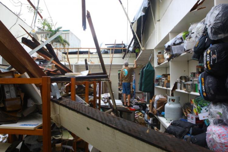 A business owner in the centre of town attempts to repair his damaged roof in Tully, after Cyclone Yasi tore through the Cassowary coast in North Queensland.  (Jonathan Wood/Getty Images)
