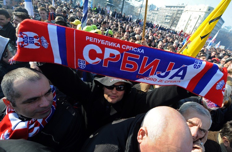 SERB NATIONALISM: A supporter of Serbian opposition holds a scarf, reading 'Serbia' and 'Kosovo is Serbia,' during a mass protest in downtown Belgrade on Feb. 5. (Andrei Alexandru/Samuel Goldwyn Films)