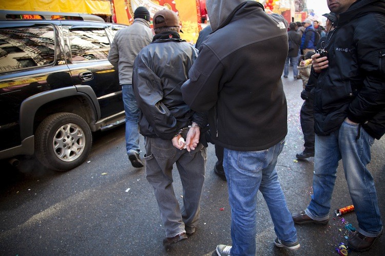 Undercover police officers arrest a man last February in Manhattan's Chinatown. According to a study, about a million criminal cases are compromised each year because suspects don't understand the right to remain silent. (Michael Nagle/Getty Images)