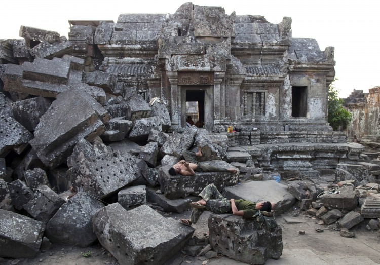 Cambodian soldiers rest on the ruins of the ancient Preah Vihear temple where a military camp was set up on February 9. Now that the ICJ has ruled the area to be a DMZ, soldiers will no longer be allowed near it.    (Paula Bronstein/Getty Images)