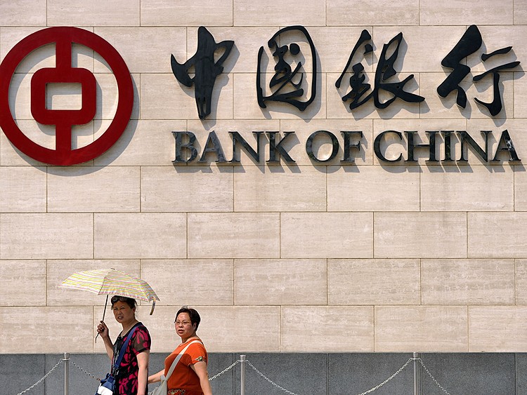 Two pedestrians walk in front of the Bank of China in Beijing in 2010. The Bank of China is involved in the latest lawsuit in which Israeli terror victims are suing the bank for being complicit in the funding of terrorist groups. (Liu Jin/AFP/Getty Images)