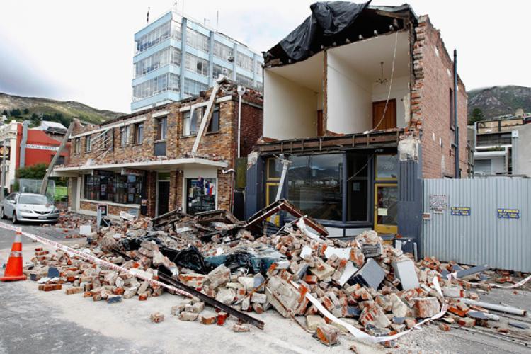 A car crushed by infrastructure damage is seen on February 24, 2011 in Christchurch, New Zealand, following a 6.3 magnitude earthquake that struck 20km southeast of Christchurch on Tuesday. (Martin Hunter/Getty Images)