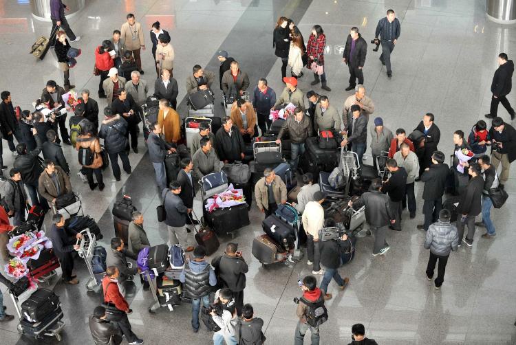 A group of Chinese citizens who were evacuated by Chinese government from Libya arrive at the Beijing Capital Airport in Beijing on Feburary 24, 2011.  (STR/Getty Images)