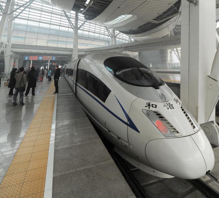 Passengers board a high-speed train at a railway station in Beijing on Feb. 21, 2011.  (AFP/Getty Images)