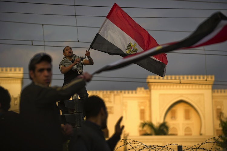 Egyptian waves his national flag 
