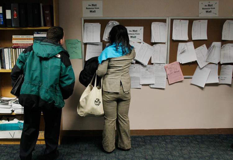 Unemployed people look over job listings on a board at a New York State Department of Labor Employment Services office March 3, 2011 in Brooklyn Borough of New York City. ( Chris Hondros/Getty Images)