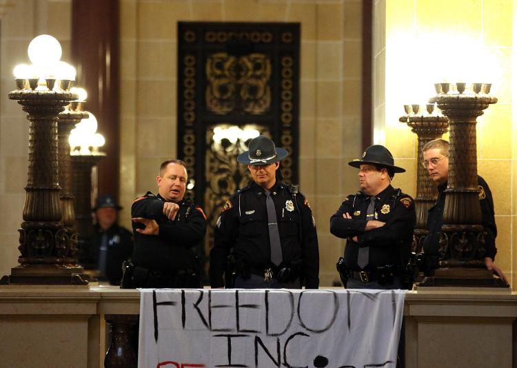 Police officers monitor protesters inside the Wisconsin State Capitol on March 4, 2011 in Madison, Wisconsin. (Justin Sullivan/Getty Images)
