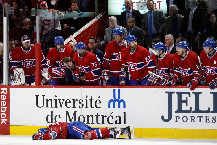 Montreal Canadiens Max Pacioretty lies motionless on the ice after being hit into a support post by Boston Bruins Zdeno Chara in Montreal on March 8. The National Hockey League came under attack from all sides in the wake of the hit as fans, sponsors, and politicians expressed outrage at the rising levels of violence in the sport. (Richard Wolowicz/Getty Images)