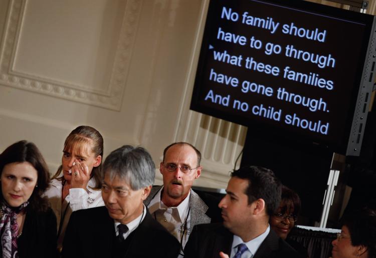 COST OF BULLYING: Laura (2nd L) and Kirk Smalley (C) weep while listening to President Barack Obama talk about their familys tragedy during a White House Conference on Bullying Prevention on March 10.  (Chip Somodevilla/GETTY IMAGES )