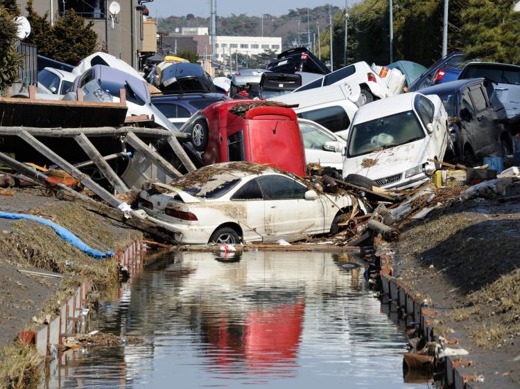 Vehicles block a canal after they were deposited there in Tagajo, Miyagi prefecture on March 13, 2011 following a massive earthquake and tsunami on March 11. (Toru Yamanaka/AFP/Getty Images)