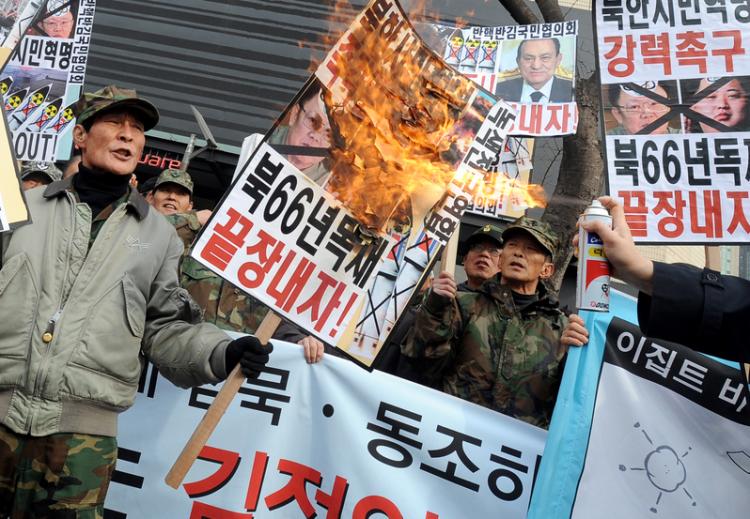 South Korean protesters burn placards showing the faces of North Korean leader Kim Jong-il and his son and likely-successor Kim Jong-un, and the ousted Egyptian president Hosni Mubarak during an anti-North Korea rally near the U.S. embassy in Seoul on Feb 16. (AFP/Getty Images)
